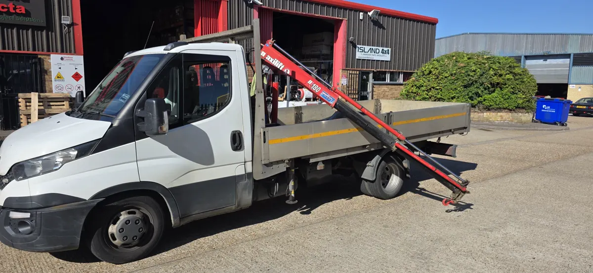 Vehicle-mounted crane on the 3.5T HIAB van with the boom extended over the dropside bed